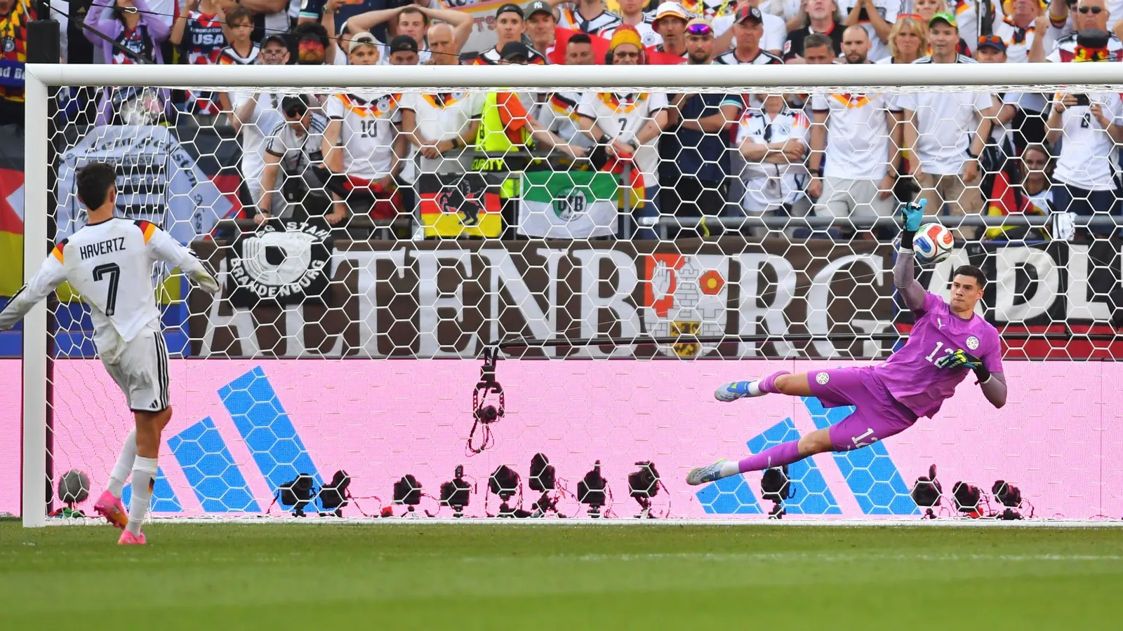 Paraguay goalkeeper Orlando Gill (12) blocks a shot by Germany's Kai Havertz (7) in a shootout during the World Cup r