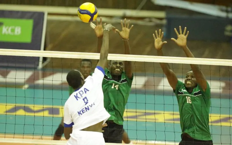 KPA’s Abraham Kiplagat (left) challenges Timon Kimutai and Dennis Ireke of Prisons Kenya at the net finishing in the third place 3-2 at the Mozzart Kenya Cup on July 26, 2026.[Jonah Onyango, Standard].