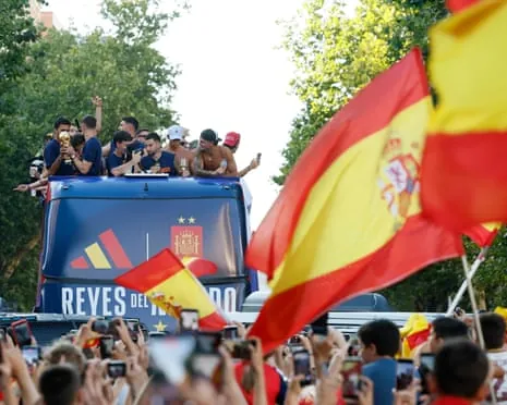 Spain’s players parade the World Cup trophy through Madrid on Monday