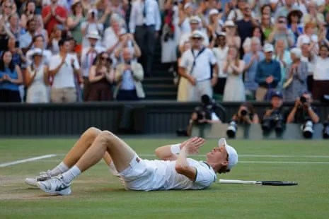 Jannik Sinnerfalls to the floor after his victory in the men’s singles final.