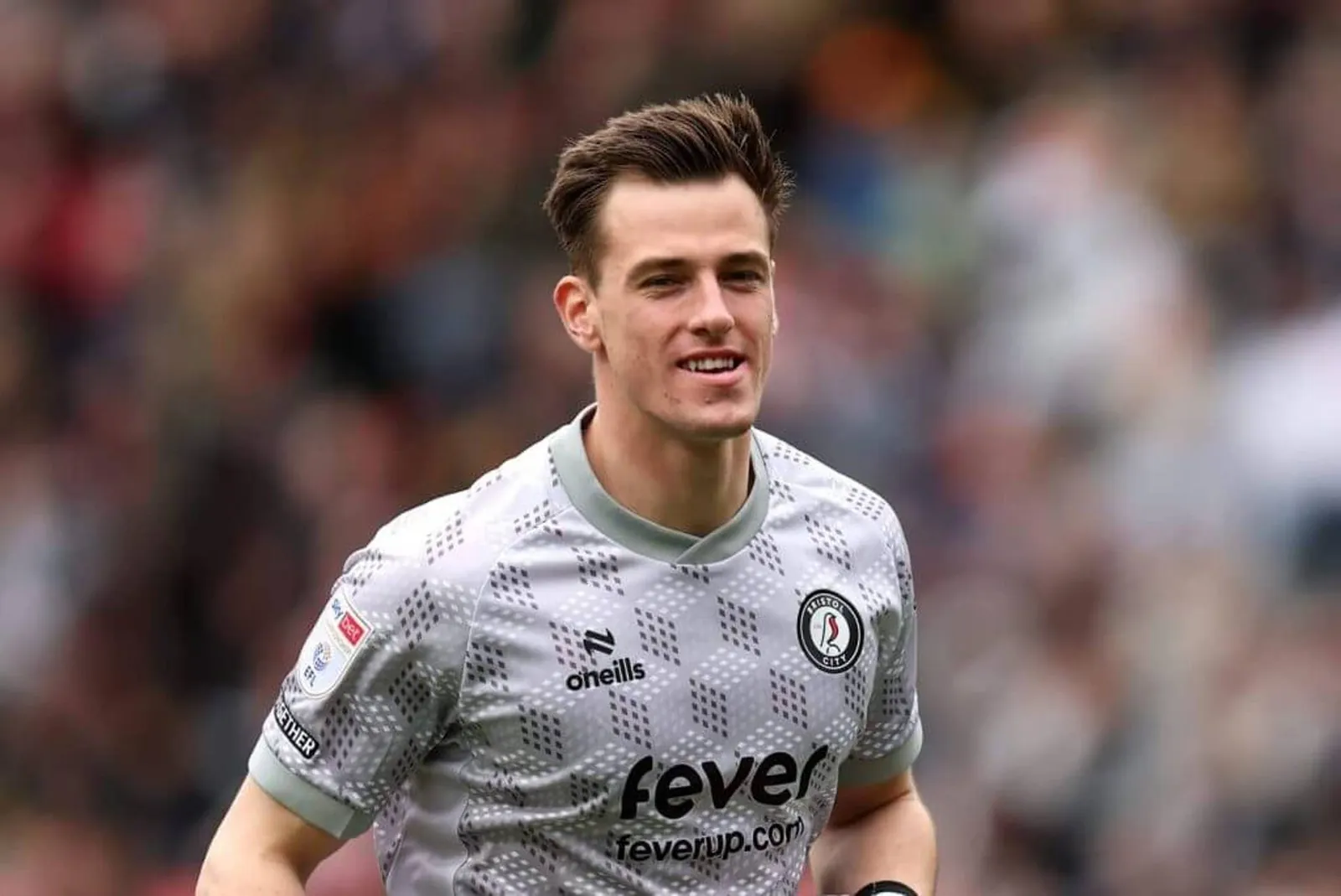 Radek Vitek, wearing a greay goalkeeper's jersey, smiles during a game.